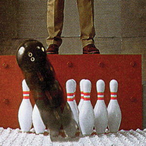 Old timey image of a bowling ball being dropped on a mattress and the 10 pins not moving.